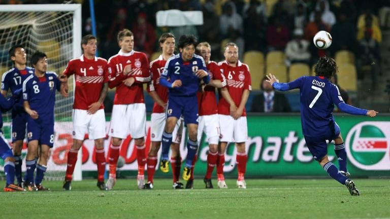 RUSTENBURG, SOUTH AFRICA - JUNE 24: Yasuhito Endo of Japan (R) scores his team's second goal from a free kick during the 2010 FIFA World Cup South Africa Group E match between Denmark and Japan at the Royal Bafokeng Stadium on June 24, 2010 in Rustenburg, South Africa. (Photo by Ian Walton/Getty Images)