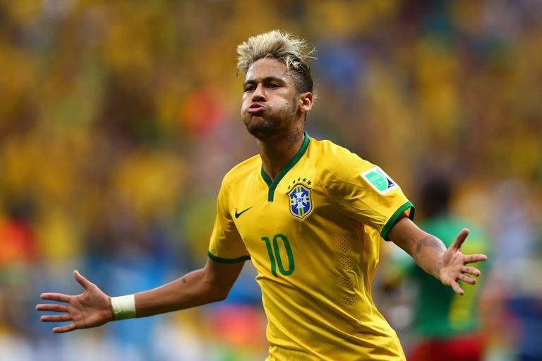BRASILIA, BRAZIL - JUNE 23: Neymar of Brazil celebrates scoring his team's second goal and his second of the game during the 2014 FIFA World Cup Brazil Group A match between Cameroon and Brazil at Estadio Nacional on June 23, 2014 in Brasilia, Brazil.  (Photo by Clive Brunskill/Getty Images)